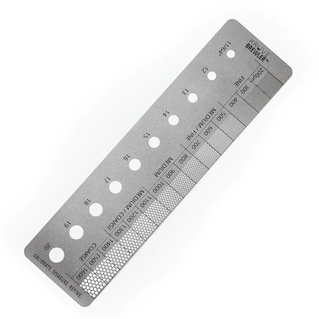 Kruve Brewler: a stainless steel ruler with graded mesh windows for measuring coffee grind size in microns, from fine to coarse
