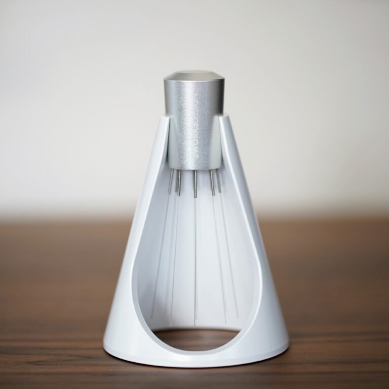 Sworksdesign WDT tool with fine needles, standing in its white cone-shaped stand